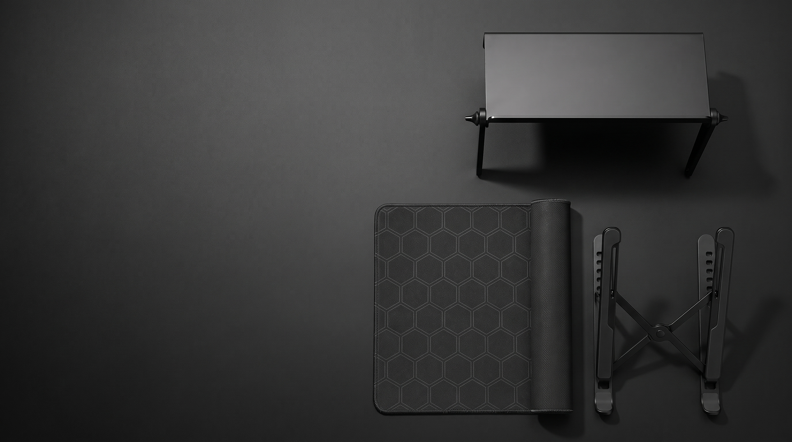 The Complete Setup — screen-top shelf, hex desk mat and adjustable laptop stand, top-down