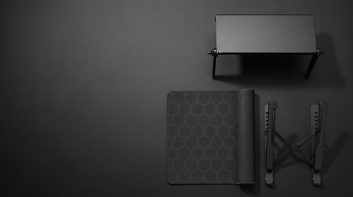 The Complete Setup — screen-top shelf, hex desk mat and adjustable laptop stand, top-down